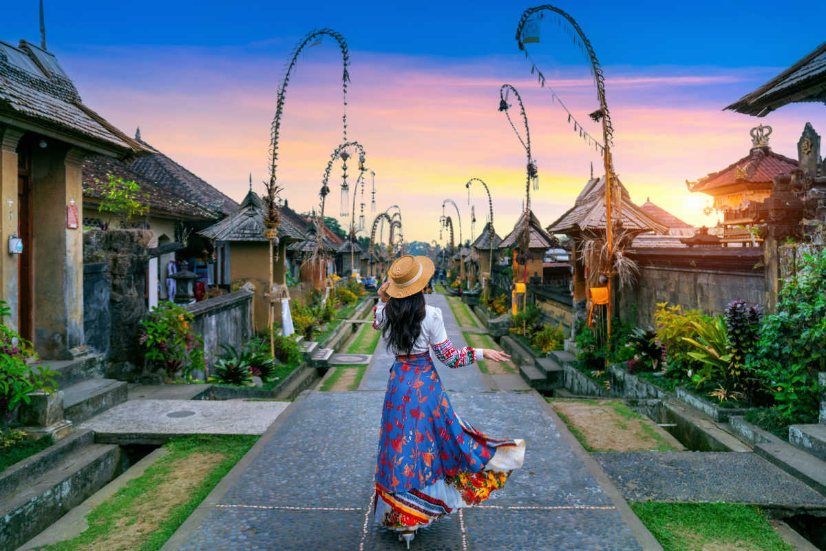 Woman walks through Penglipuran Village at sunset in Bali.jpg