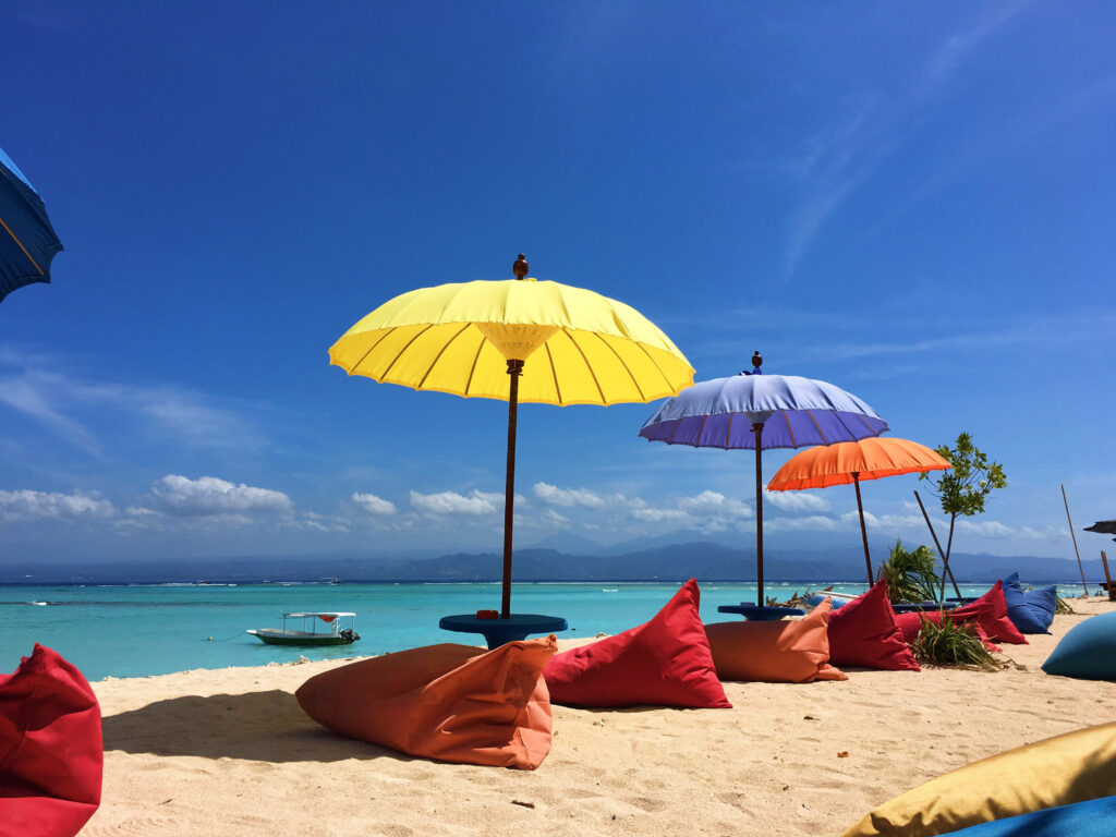 Colorful,Umbrellas,And,Beanbags,On,A,Beach