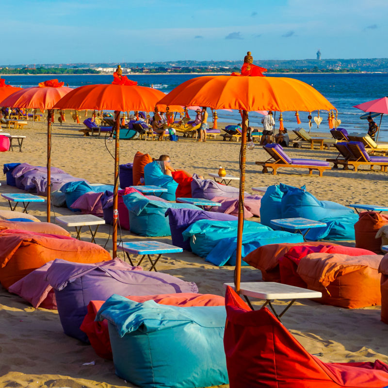 Empty-Colorful-Sun-Loungers-At-Seminyak-Beach-in-Bali