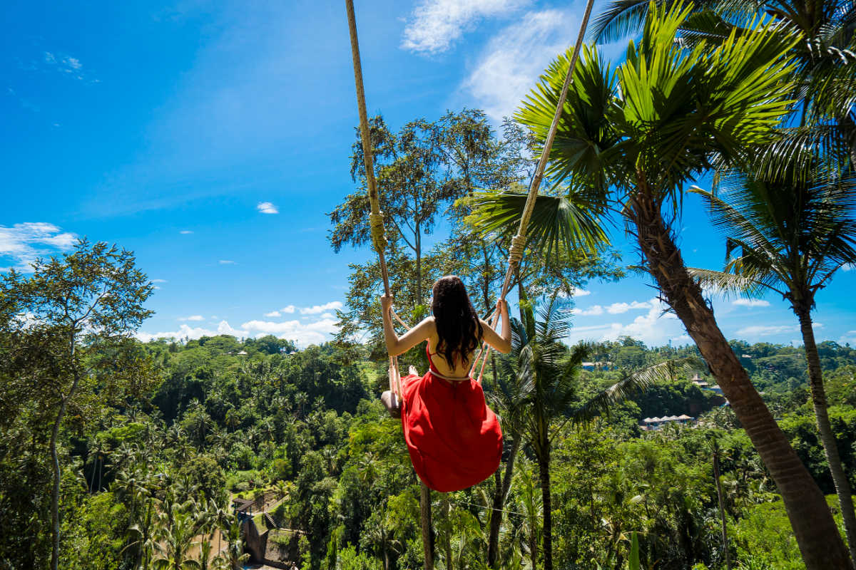 Woman on Bali swing in tree in daytime.jpg