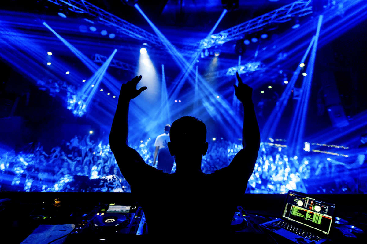 DJ in nightclub with blue lights