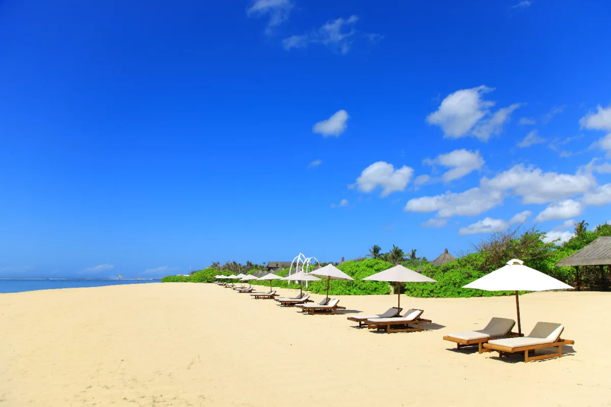 Sun loungers on Nusa Dua Beach in daytime.jpg