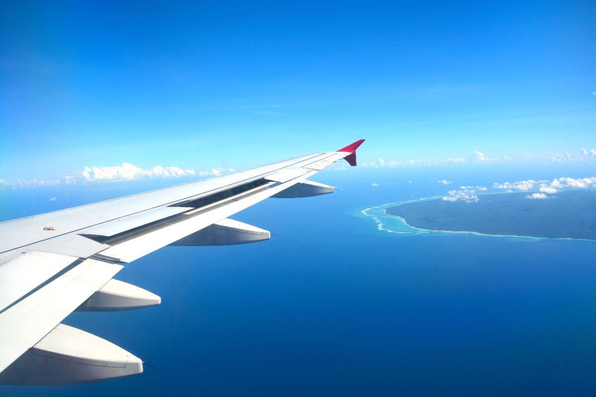 PLane flies over sea and Bali island.jpg