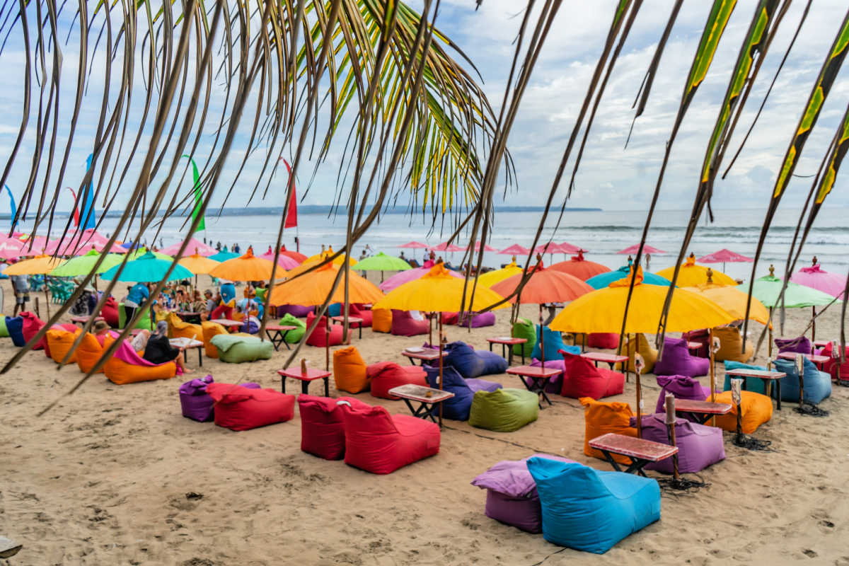 Colourful Beanbags on Seminyak Beach Under Palm Leaves on Bali Beach.jpg