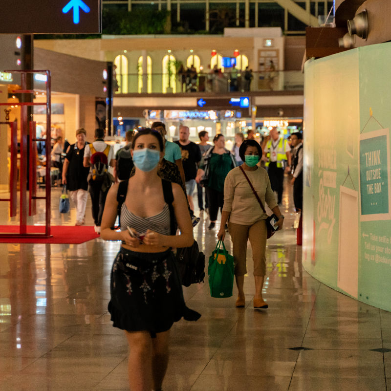 Passenger-Tourists-Walk-Through-Bali-Airport-Wearing-Masks-Protecting-Against-Covid-19