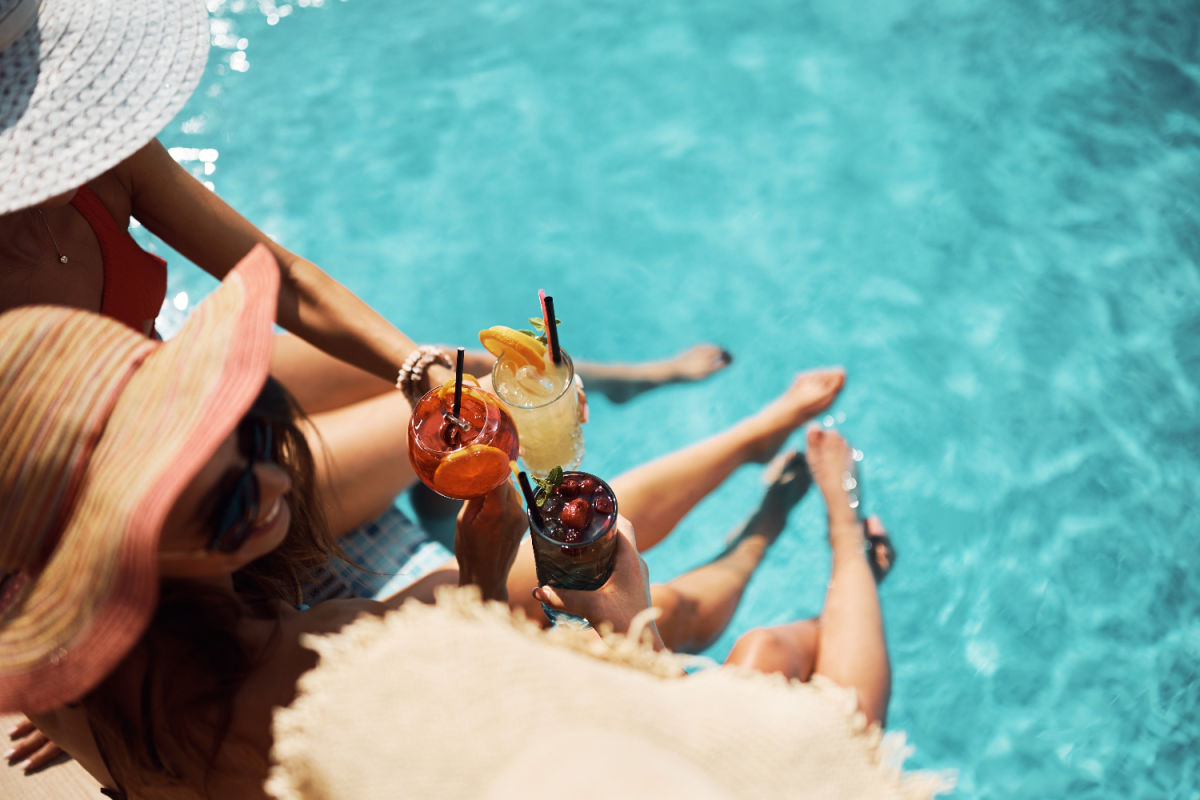 Tourists Cheers Cocktails by a pool in daytime.jpg