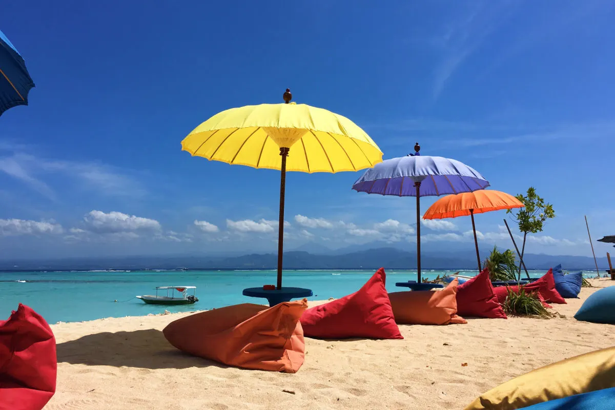 Colourful beanbags on Nusa Lembongan Beach Overlooking ocean and Bali