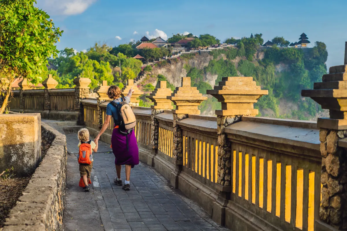 Parent and Child Walk Towards Uluwatu Temple in Bali in Daytime.jpg