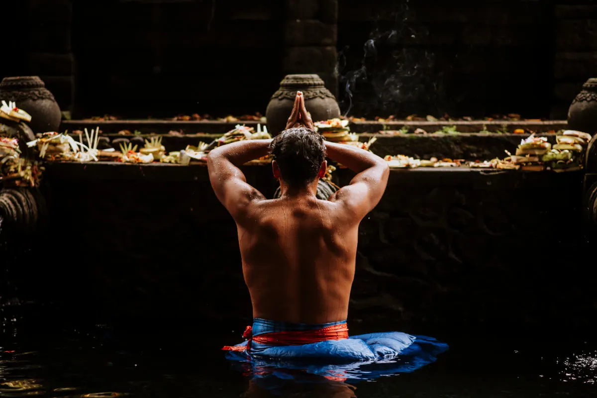 Man takes part in Melukat ceremony at Tirta Empul Temple in Bali.jpg