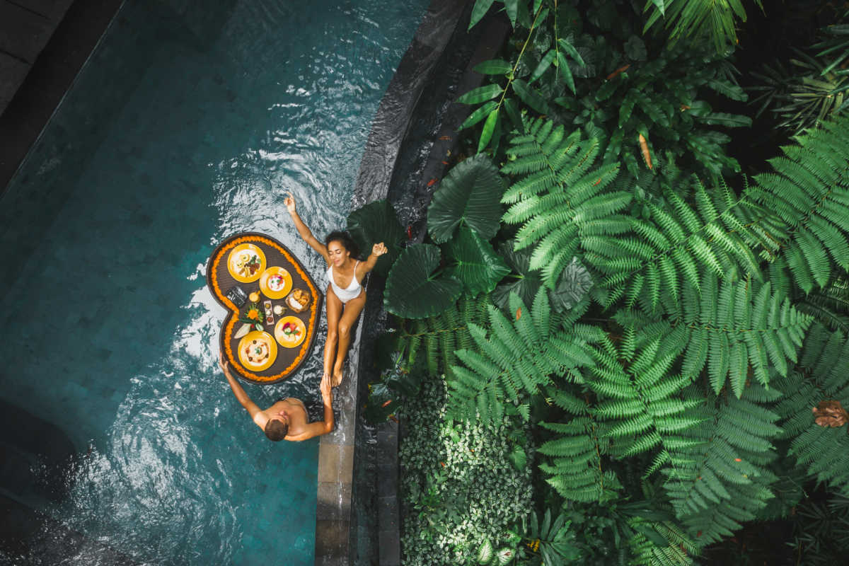 Tourist couple enjoy floating breakfast in pool in Bali.jpg