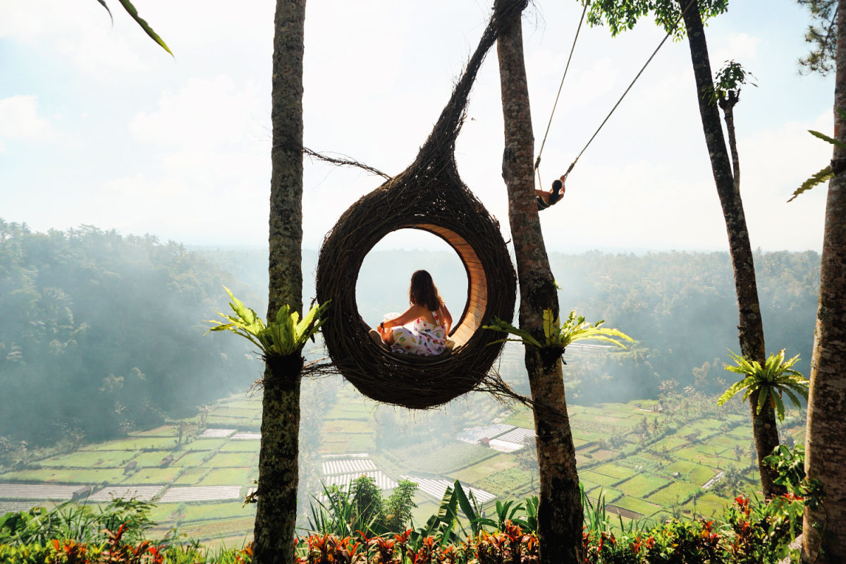 Woman Sits in Bali Photo Nest Overlooking Rice Paddies.jpg