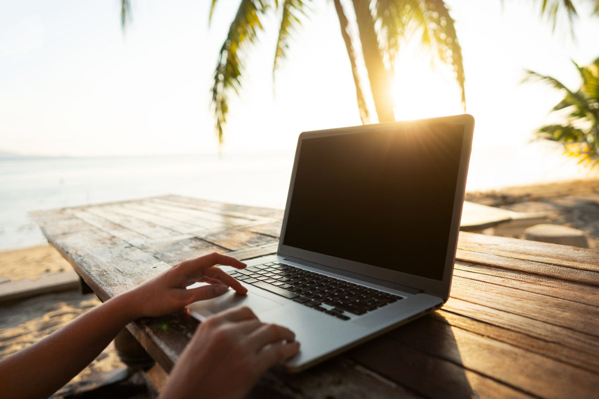 laptop on a table under a palm tree.jpg