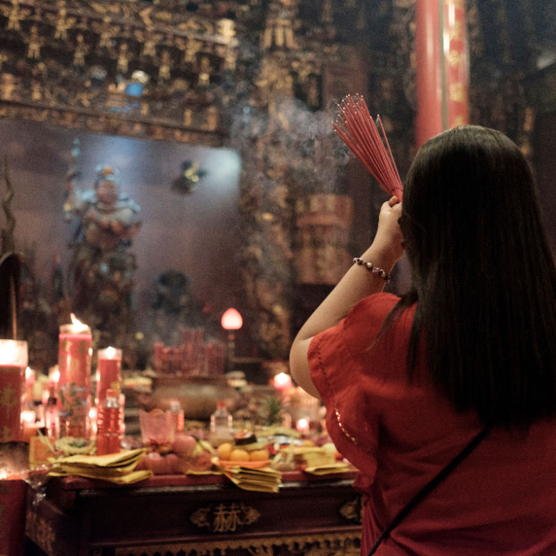 Woman-Prays-At-Chinese-Temple