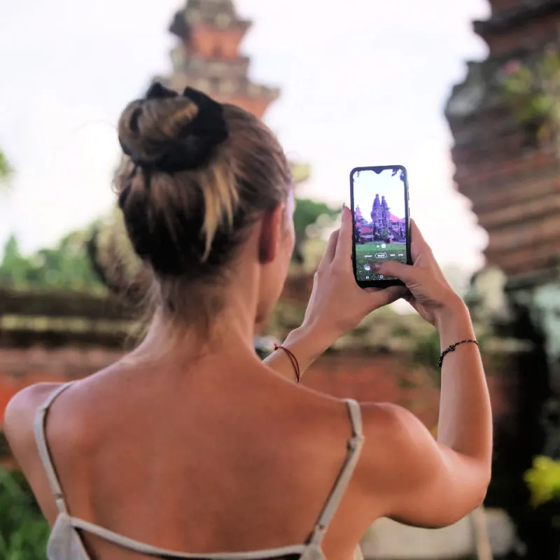 Woman-takes-photo-of-Bali-temple-on-her-phone
