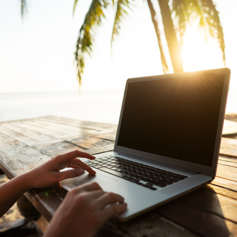 laptop-on-a-table-under-a-palm-tree