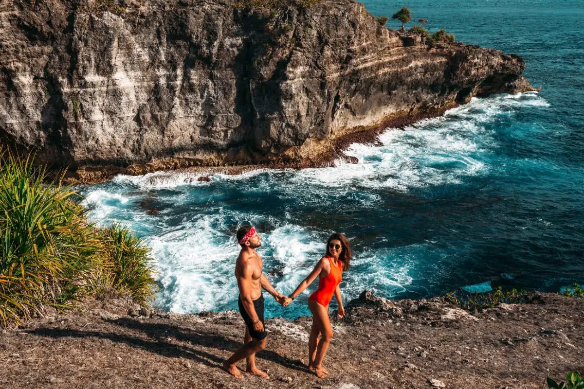 Tourist Couple Walk Along Clifft Top in Nusa Islands in Bali.jpg