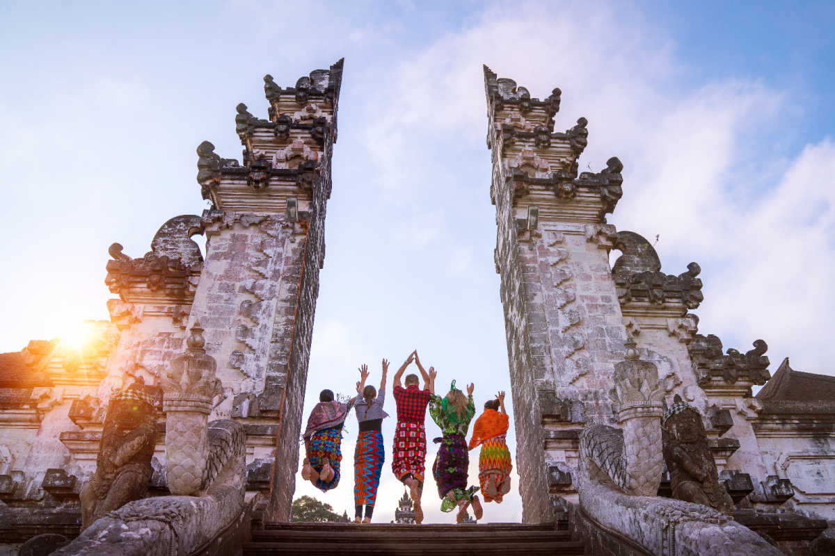 Tourists Pose Between Gates Of Heaven Temple in Bali.jpg