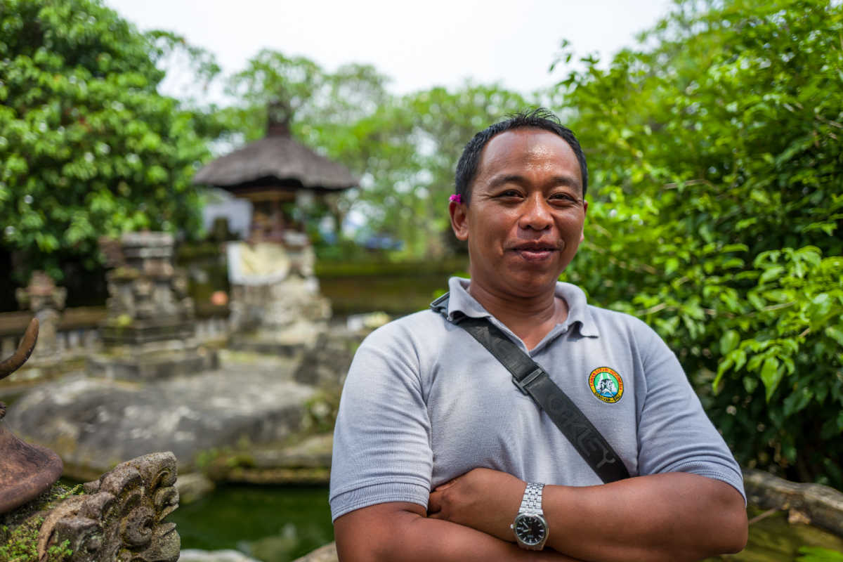 Tour Guide Stands By Bali Temple.jpg