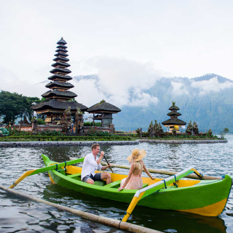 Couple-On-Boat-On-Lake-Beratan-by-Temple-in-Bali