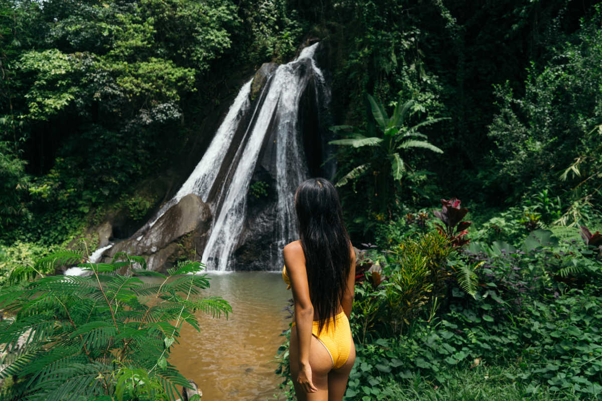 Woman Tourist Stands in Front of Bali Waterfall.jpg