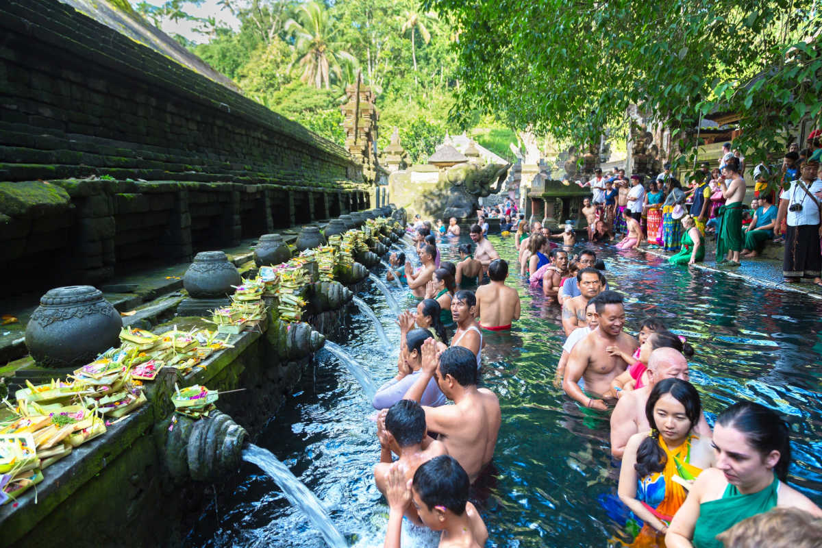 Tourists Line Up To Do Melukat at Tirta Empul Temple in Bali.jpg