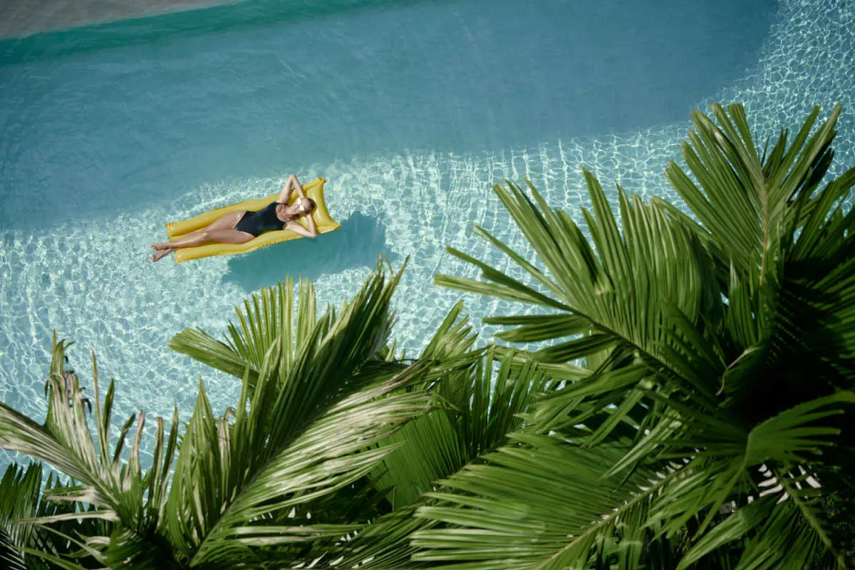 Woman Relaxes in Tropical hotel Swimming Pool.jpg