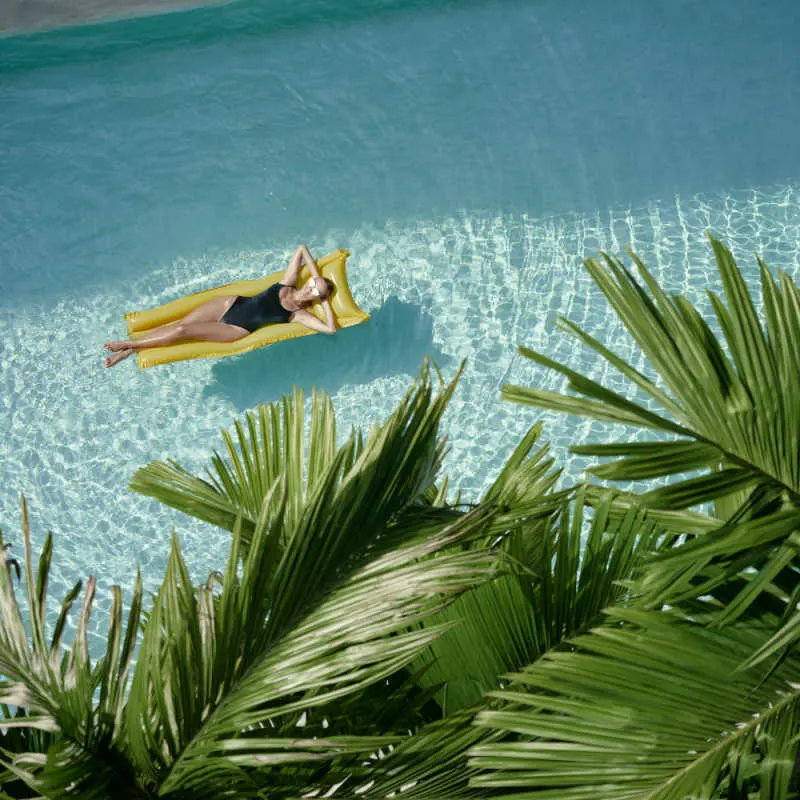 Woman Relaxes in Tropical hotel Swimming Pool.jpg