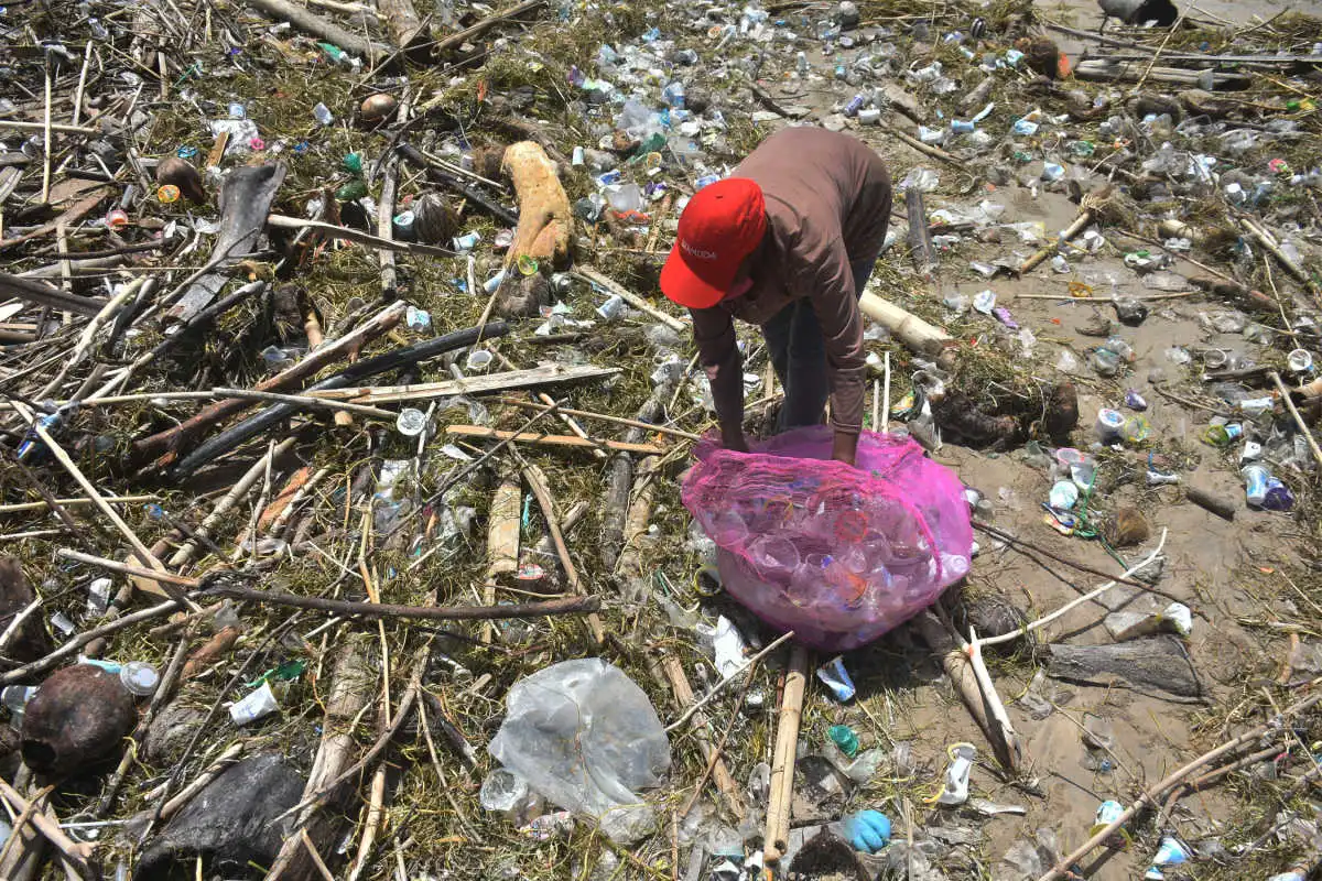 Tide Of Waste on Bali Beach Local Worker Clean Up.jpg