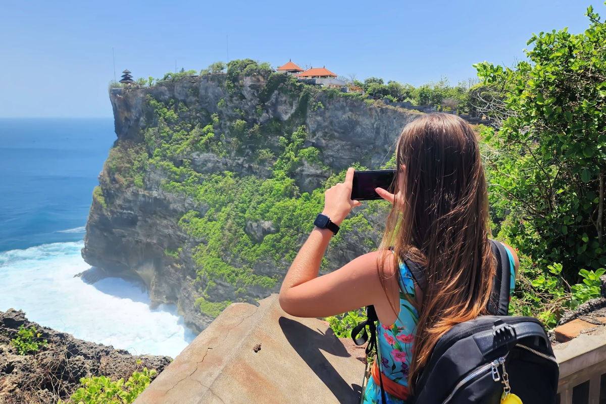Tourist Takes Photo Over Cliff at Uluwatu Bali.jpg