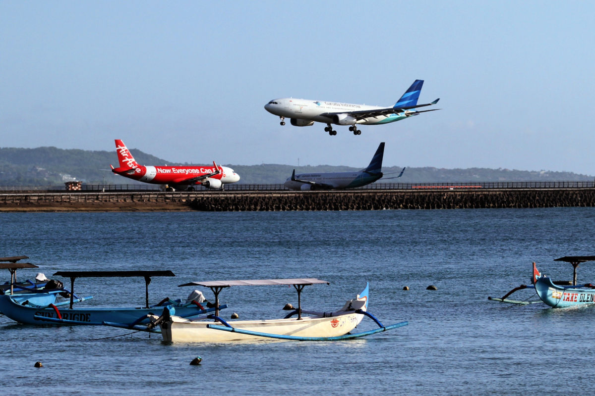Planes come into land on runway over ocean in Bali.jpg