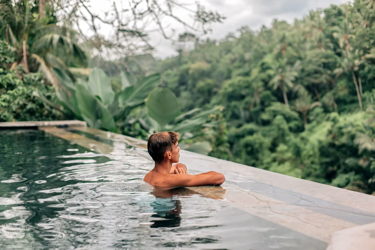 Man in infinity pool in Bali luxury jungle villa.jpg