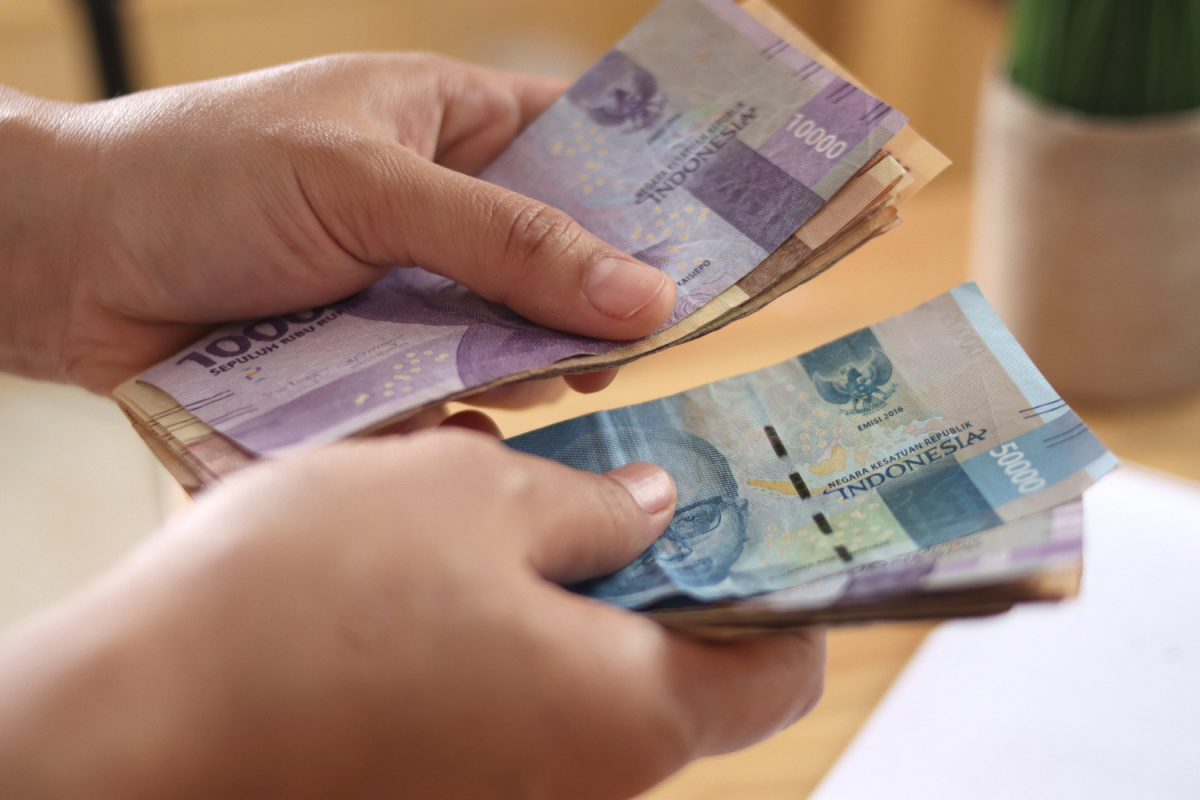 Close up of Indonesian Rupiah IDR Cash Money in Hands.jpg