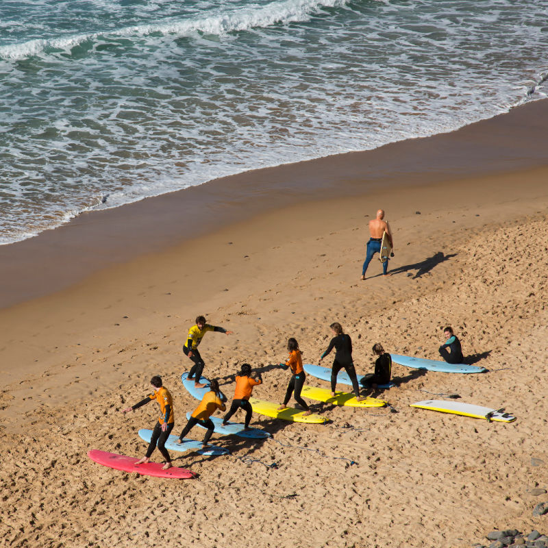 Group of Tourists Get Surf Lesson on Bali Beach.jpg