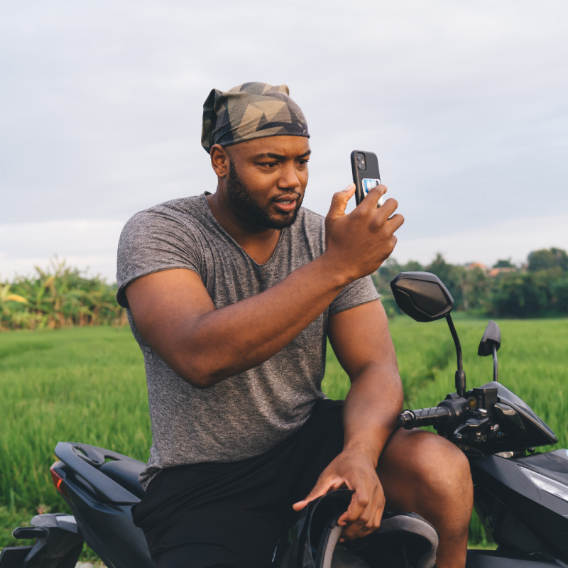 Man-in-Bali-on-Phone-On-moped-in-Rice-Paddie