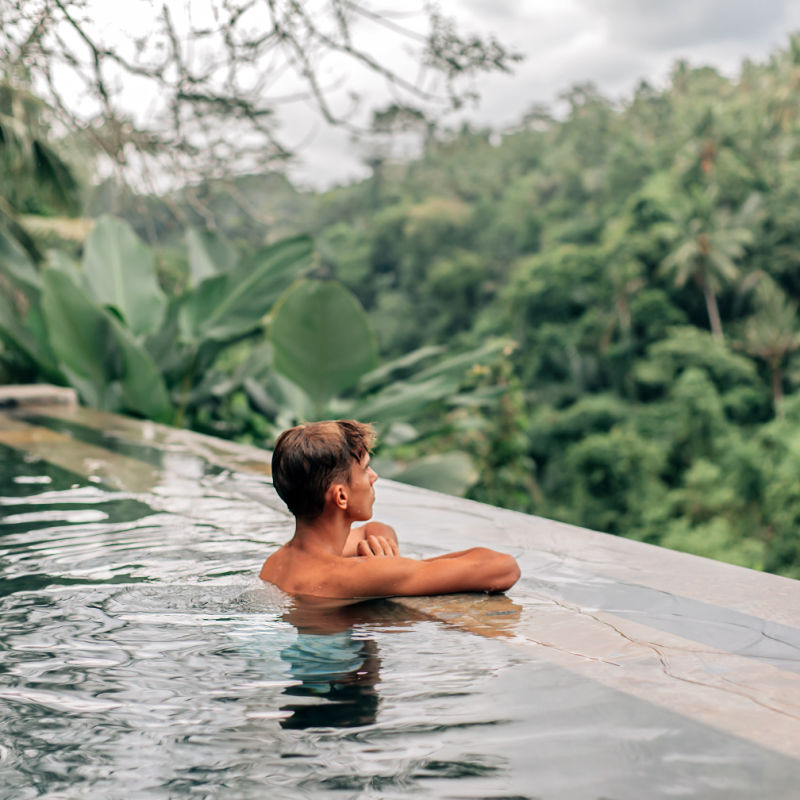 Man-in-infinity-pool-in-Bali-luxury-jungle-villa