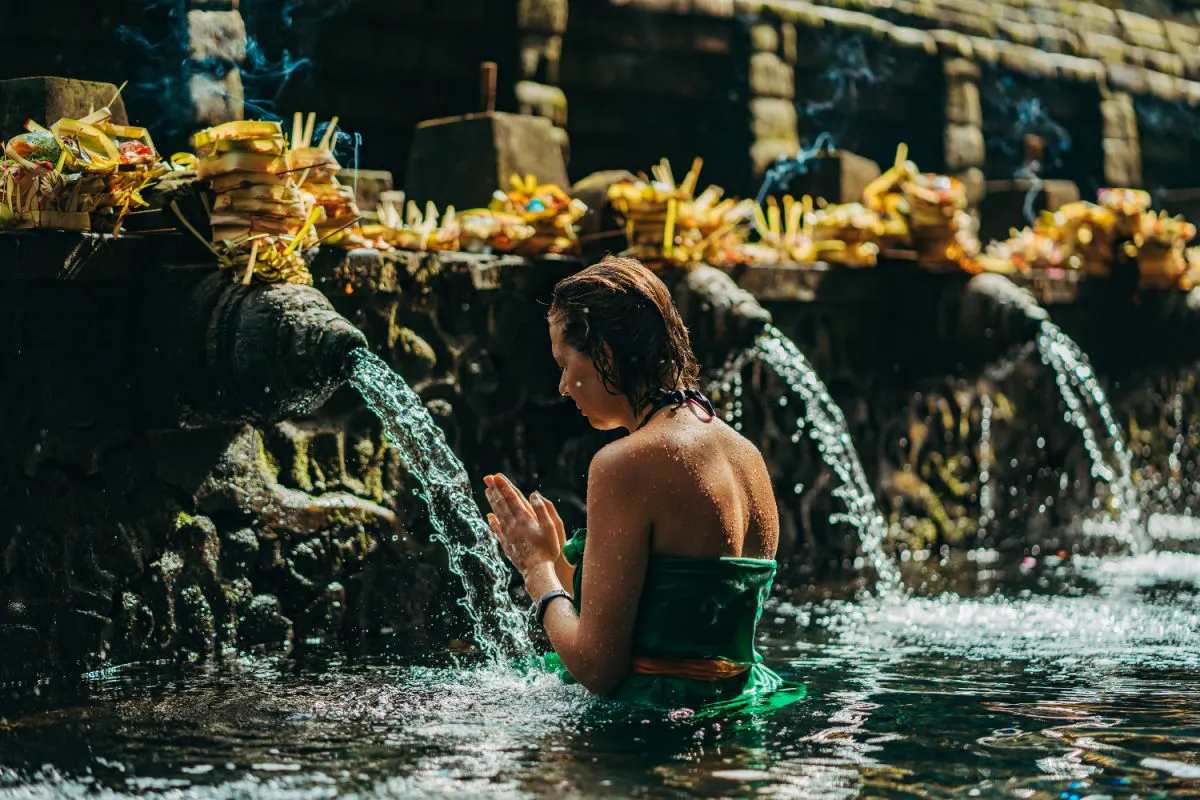 Woman at Tirta Empul Temple in Bali.jpg