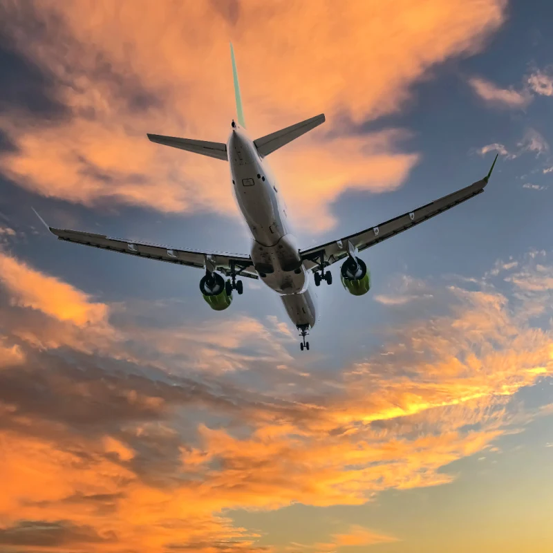 Airplane-In-Sky-At-Sunset