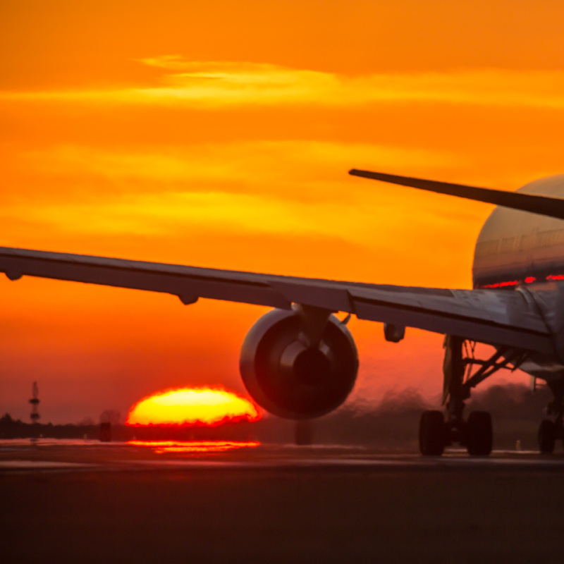 Airplane-on-runway-at-sunset