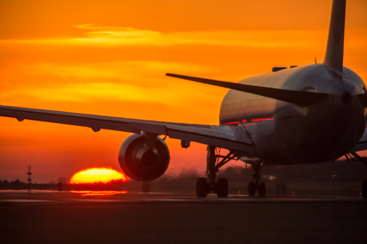Airplane on runway at sunset.jpg