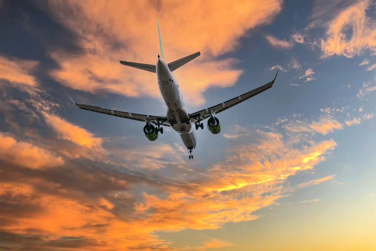 Airplane In Sky At Sunset.jpg
