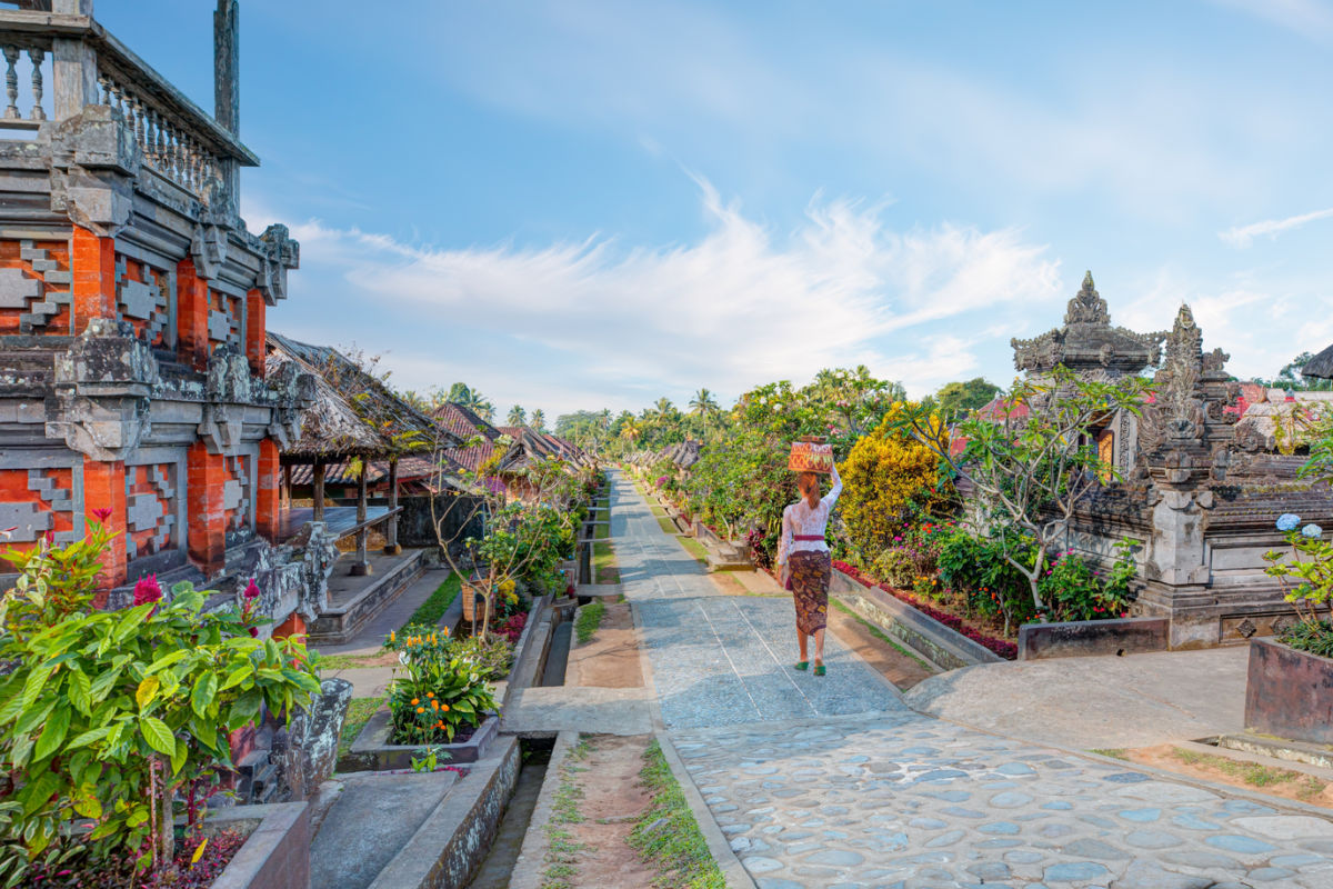 Woman Walks Through Penglipuran Village Bali