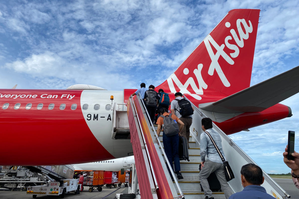 Tourists Board AirAsia Plane.jpg