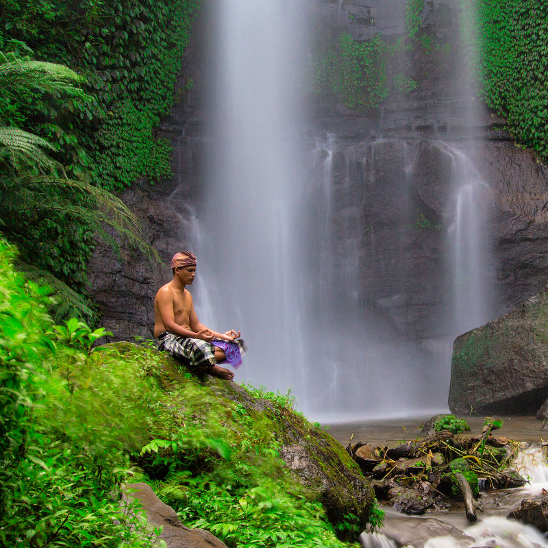 Man-Meditates-at-Waterfall-in-Munduk