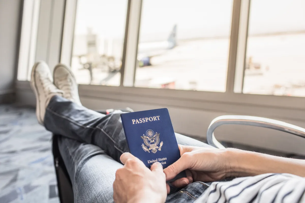 American-Passport-Holder-Sits-Waiting-at-Airport