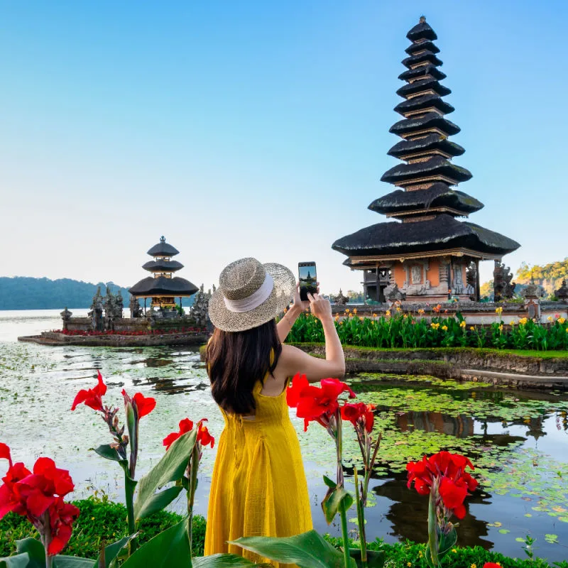 Woman Stands at Ulun Danu Beratan Temple in Bali.jpg
