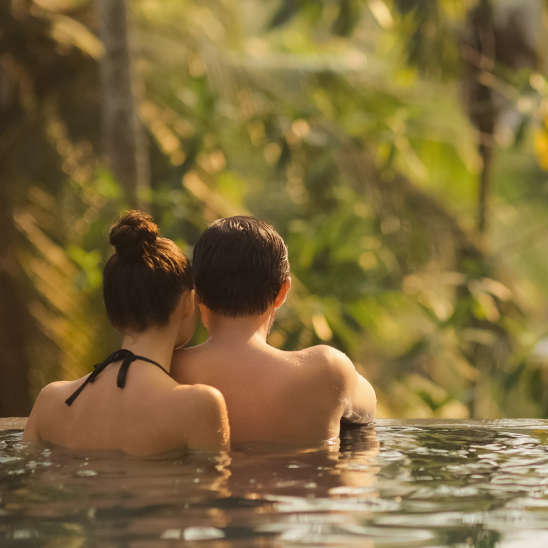 Couple-look-out-at-jungle-from-infinity-pool