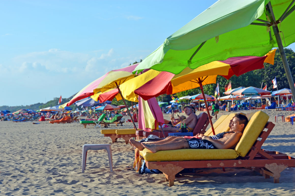 Tourists Sunbath on Legian Beach in Bali.jpg