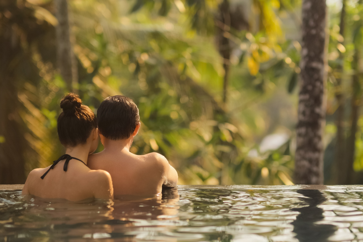 Couple look out at jungle from infinity pool.jpg