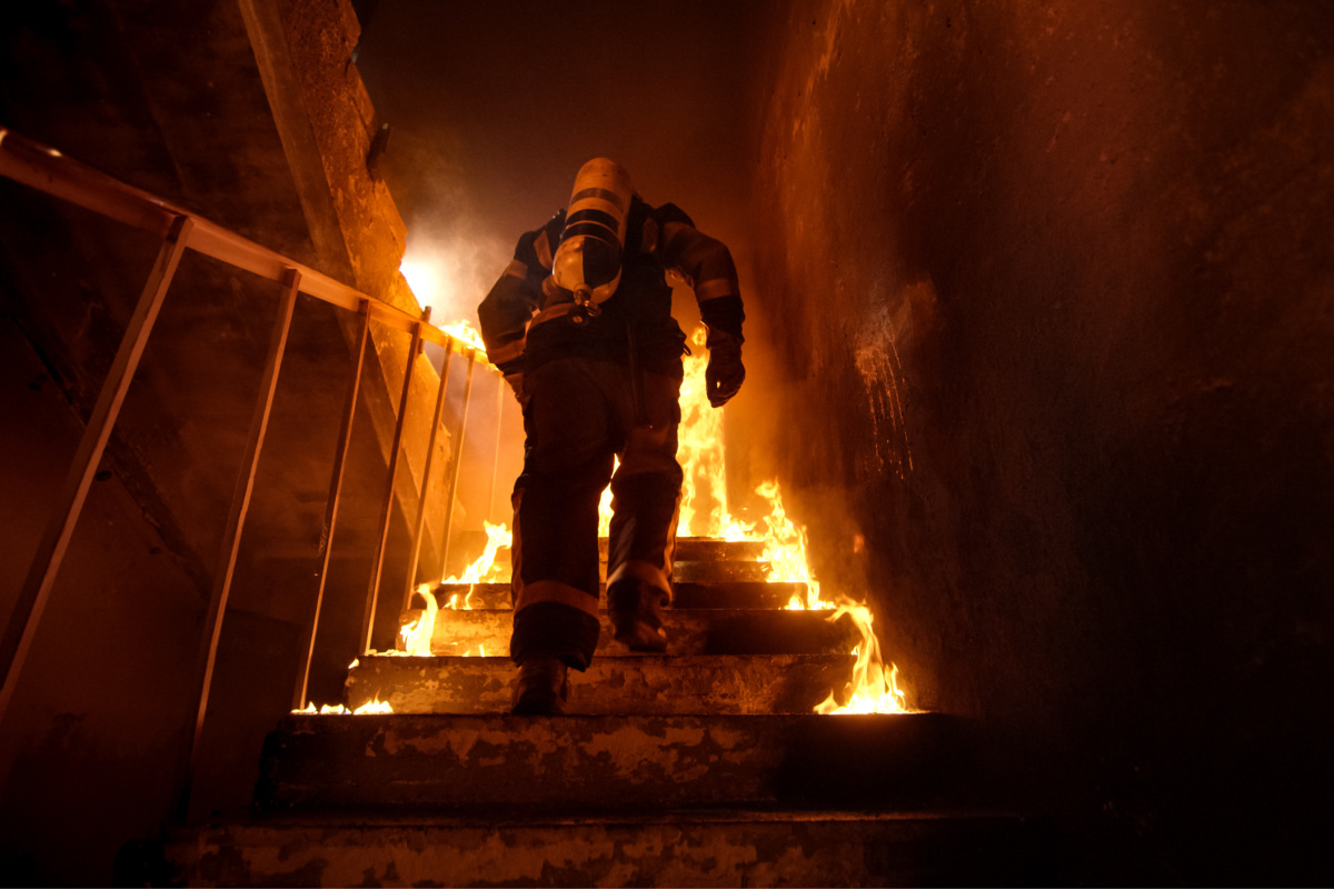 Firefighter climbs stairs in Burning BUilding.jpg