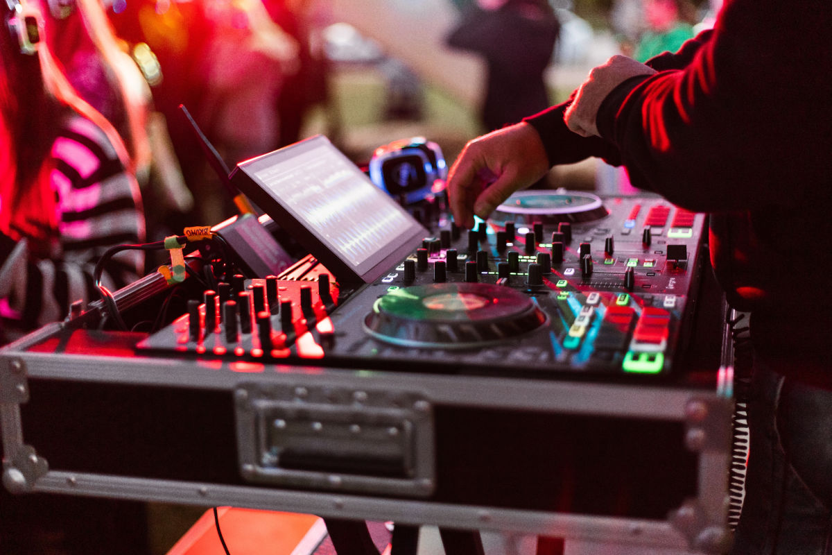 DJ on decks at party club nightlife event.jpg